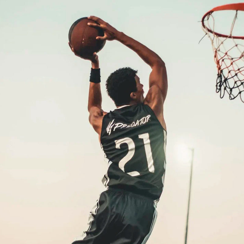 Man about to dunk on a basketball court - Jersey